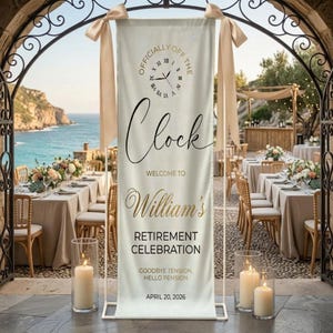 May include: A banner for a retirement celebration with the text "Officially Off The Clock" and "William's Retirement Celebration." The banner is cream-colored with gold and black lettering, and is decorated with cream-colored ribbons. The background shows a seaside setting with tables and chairs.
