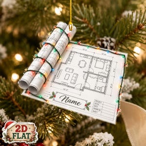 May include: A flat, rectangular Christmas ornament featuring a printed architectural floor plan with dimensions, rolled blueprints, and a string of multicolored LED lights. The design includes a box labeled Name and a project information table.