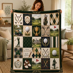 May include: A quilted throw blanket featuring a grid of golf-themed squares, including images of golf clubs, balls, a cart, a trophy, a clubhouse, a scorecard with the text 'Play Well Enjoy the Game', and a pair of golf shoes in shades of green and tan.