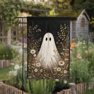 May include: A rectangular garden flag featuring a white ghost illustration centered against a dark, starry night sky background. The ghost is surrounded by detailed botanical illustrations of various wildflowers, daisies, and dried grasses in earthy tones.