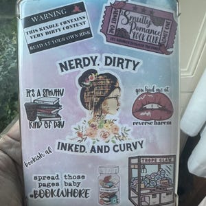 May include: A pink and blue Kindle cover with various stickers. The stickers include a warning that the Kindle contains very dirty content, a book club ticket, a nerdy and dirty sticker, a bookish af sticker, a spread those pages baby sticker, and a trope claw sticker.
