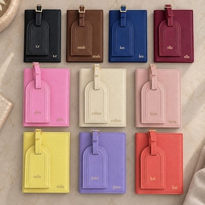 May include: A collection of twelve rectangular passport holders with matching luggage tags, each featuring a gold-toned buckle and personalized name embossed in gold. The set includes black, brown, blue, burgundy, pink, cream, rose, yellow, purple, and red.