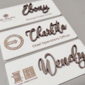 White badge with Rose Gold Text and Logo.
Font: Amigirl