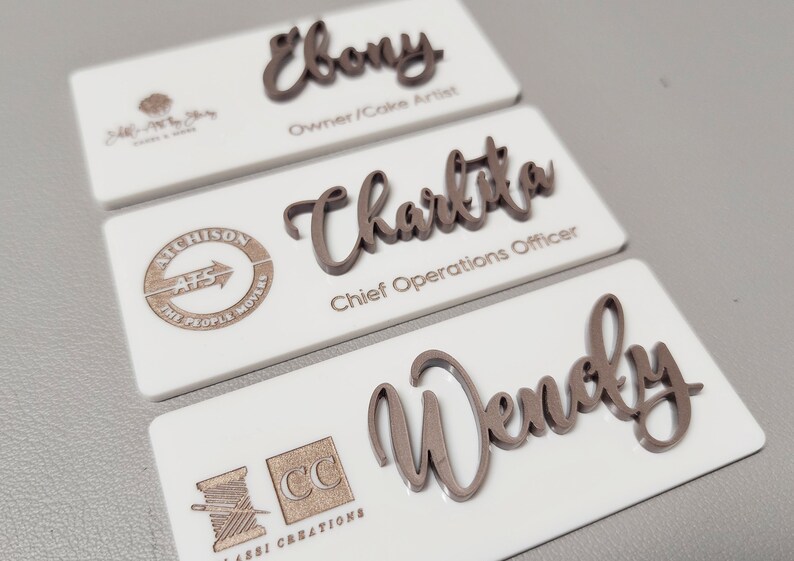 White badge with Rose Gold Text and Logo.
Font: Amigirl