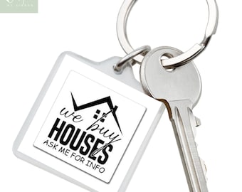 May include: A white square keychain with a black house graphic and the text "We Buy Houses Ask Me For Info". The keychain is attached to a silver key ring and a silver key.
