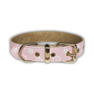 May include: Pink dog collar with a white floral pattern and gold-colored hardware. The collar features a buckle closure and a D-ring for leash attachment. The interior of the collar is a light brown color.