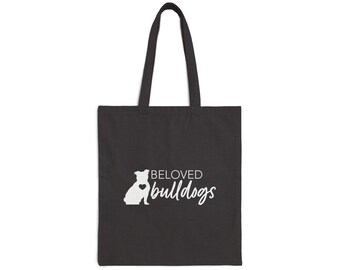 May include: Black tote bag with white text that reads "BELOVED bulldogs" and a white silhouette of a bulldog with a heart on its chest.