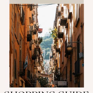May include: A digital guide titled La Vintagetta SECRET NAPLES SHOPPING GUIDE for the Made in Italy lover, featuring a vertical view of a narrow street in Naples with tall orange buildings, balconies, and a distant green hill under a bright sky.
