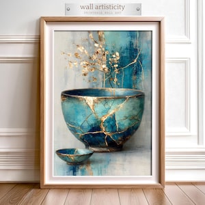 Op de afbeelding: Ingelijste wandkunst met een turquoise kom met gouden accenten, met een kintsugi-ontwerp. Het kunstwerk bevat een kleinere kom en gouden bloemelementen tegen een blauw-witte achtergrond. De tekst "wall artisticity" staat bovenaan.