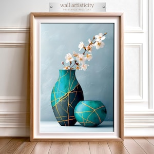 May include: A framed print featuring two teal vases with gold crackle patterns, one tall and one round, holding white flowering branches. The background is a light blue with the text "wall artisticity PRINTABLE WALL ART".