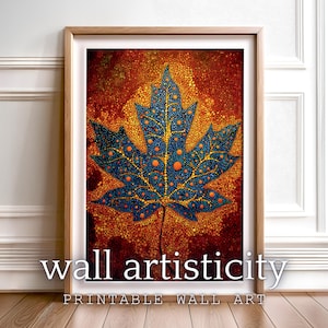 May include: Framed wall art with a maple leaf design. The leaf is blue with orange dots, set against a textured orange and brown background. The text "wall artisticity" and "PRINTABLE WALL ART" are at the bottom.