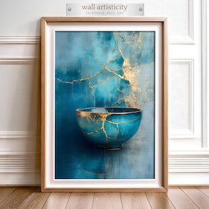 May include: Framed wall art featuring a teal bowl with gold accents, set against a textured blue background. The artwork has a kintsugi style, with gold lines highlighting the cracks. The frame is a light wood color, and the art is labeled "wall artisticity".