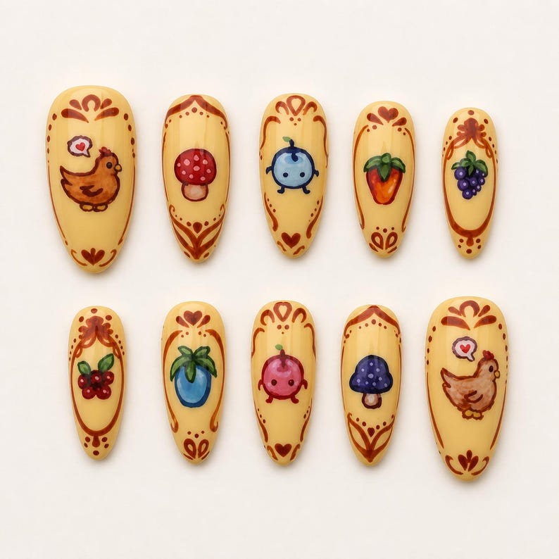 May include: A collection of ten almond-shaped false nails with a cream base. Each nail is hand-painted with a different design, such as a chicken, mushroom, blueberry, strawberry, and grapes. The designs are framed with brown decorative patterns.