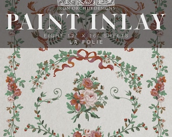 May include: Paint inlay sheets with floral and botanical patterns. Each sheet measures 30.5 x 40.6 cm. The design includes pink and orange roses and green foliage, with the text "PAINT INLAY" and "LA FOLIE".