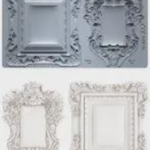 May include: A gray silicone mold featuring two ornate picture frame designs. Below, two finished white resin frames are displayed, showcasing the intricate details of the molds. The frames have detailed floral and scrollwork.