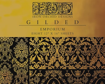 May include: A decorative paper set featuring ornate, gold-colored floral and damask patterns on a black background. The set includes eight 12" x 16" sheets. The brand name "Iron Orchid Designs" and the word "GILDED" are displayed prominently.