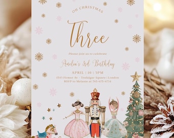 May include: A white and gold Christmas-themed birthday invitation with a pink snowflake design. The invitation says "Oh Christmas Three" and "Andin's 3rd Birthday". The invitation also includes a picture of a Nutcracker, a ballerina, and a Christmas tree.