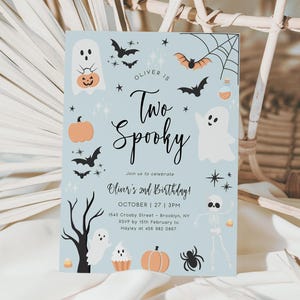 May include: A blue and white Halloween-themed birthday invitation with the text "Oliver is Two Spooky" and details for a party on October 27th at 3pm. The invitation features illustrations of ghosts, bats, pumpkins, and a spider.