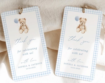 May include: Two blue and white gingham thank you tags with a watercolor illustration of a teddy bear holding a blue balloon. The text on the tags reads "Thank you for celebrating with us! With love, Sophia & Jackson 10.04.2025".