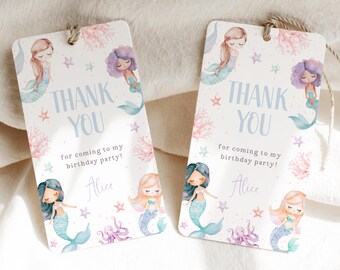 May include: Two thank you tags with a mermaid theme. The tags are white with pink and blue watercolor mermaids, coral, and starfish. The text on the tags reads "Thank You" and "for coming to my birthday party!" with the name "Alice" at the bottom.