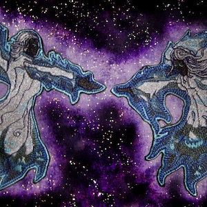 May include: Two embroidered patches of figures with flowing white robes and blue and silver accents, set against a purple galaxy background.