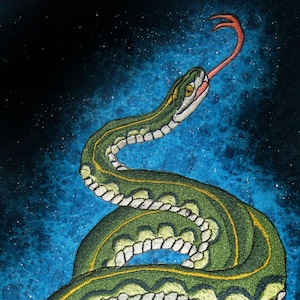 May include: A green snake with a yellow stripe is embroidered on a blue background with white glitter. The snake is coiled and its tongue is sticking out.