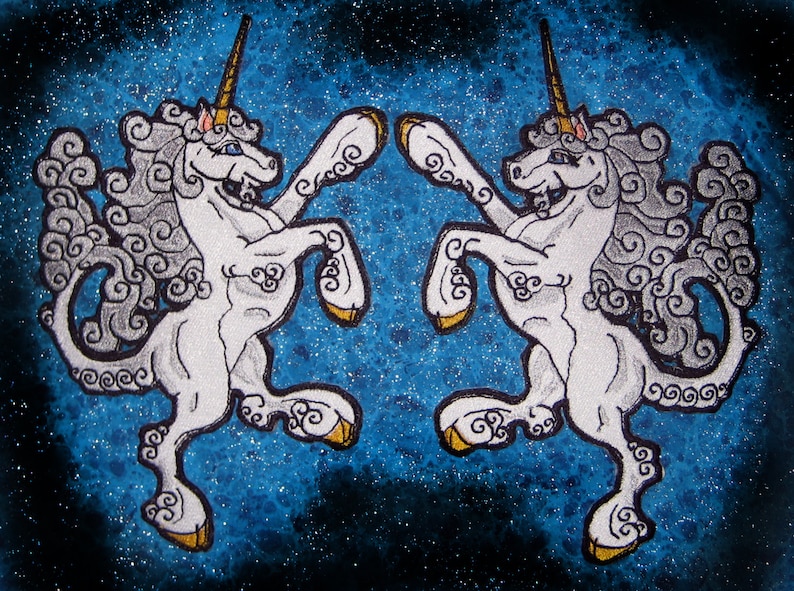 May include: Two white unicorns with gold horns and hooves are facing each other on a blue background with white glitter. The unicorns have swirling white manes and tails.
