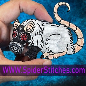 May include: White embroidered patch of a rat wearing a black gas mask with red lenses. The rat has a curled tail and is sitting on its haunches. The patch is on a blue background. WWW.SpiderStitches.com is printed below the patch.