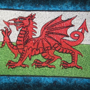 May include: Embroidered patch featuring the Welsh flag, a red dragon on a white and green background.