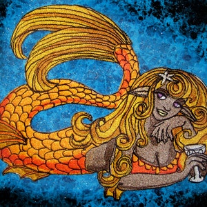 May include: Embroidered patch of a mermaid with long blonde hair, wearing a red and orange top, holding a glass of wine. The mermaid has a gold tail with orange scales and a starfish in her hair. The background is a blue and black starry sky.