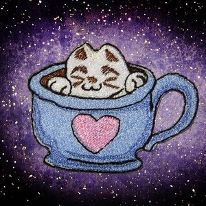 May include: A blue teacup with a pink heart design and a white cat with brown eyes and whiskers inside. The cat is curled up in the cup and appears to be sleeping. The background is a purple and white sparkly fabric.