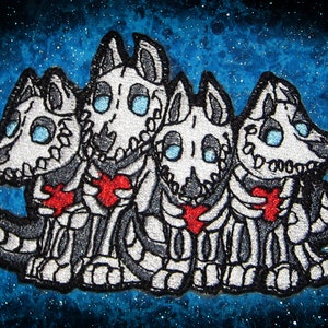 May include: Embroidered patch featuring four skeletal dogs with red hearts, against a blue and white starry background.