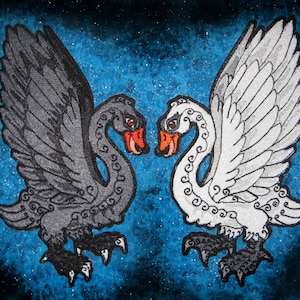 May include: Two stylized swans facing each other, one black and one white, with intricate patterns on their bodies and wings. The swans are set against a blue background with white speckles.