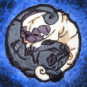 May include: Embroidered patch of two pugs in a yin yang design. The pugs are in black and white, with one pug's head on the other's body.