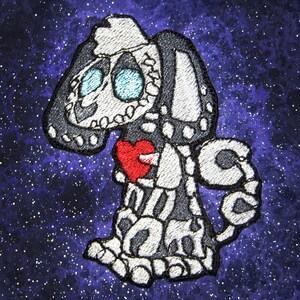 May include: A black and white embroidered patch of a skeleton dog holding a red heart. The dog is in a space-like background with stars.