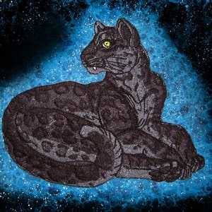 May include: A black panther with a spotted pattern is lying down on a blue background with white speckles. The panther has a yellow eye.