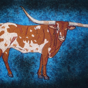 May include: A brown and white Longhorn steer with long horns against a blue sparkly background.