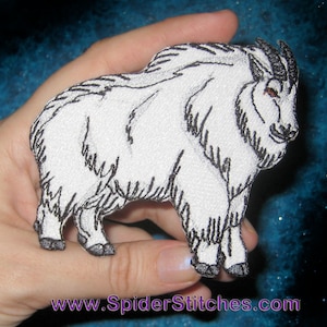 May include: White embroidered patch of a mountain goat with black outlines. The goat is standing on all four legs with its head turned to the side. The patch is approximately 4 inches tall and 3 inches wide.