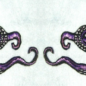 May include: Two purple embroidered octopus designs with black outlines. The octopus designs are facing each other and have their tentacles intertwined.