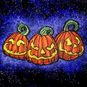 May include: Three orange jack-o'-lantern pumpkins with stitched-on faces against a dark blue starry background.