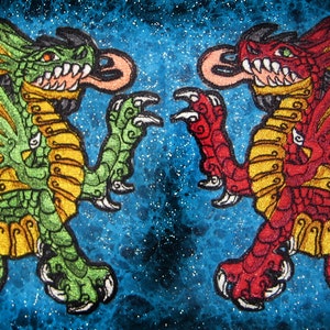 May include: Two embroidered dragons facing each other. The dragon on the left is green with yellow accents, and the dragon on the right is red with yellow accents. Both dragons have outstretched wings and are set against a blue starry background.