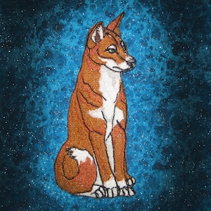 May include: A brown and white dog with a long snout and pointy ears sits on a blue background with white speckles. The dog is looking to the right of the image.