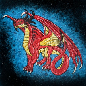 May include: Red dragon with black horns and wings embroidered on a blue background with white stars.