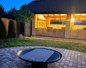 Rond roestvrijstalen grillrooster met handgrepen voor vuurplaats