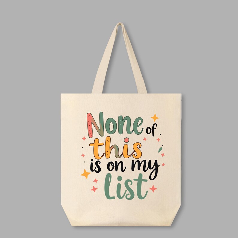 May include: A white canvas tote bag with the text "None of this is on my list" in colorful, stylized lettering. The text is surrounded by small, colorful stars.