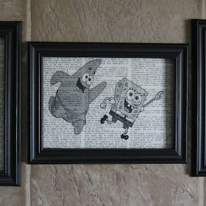 May include: Three black framed prints with white backgrounds featuring characters from the cartoon Spongebob Squarepants. The prints depict Spongebob and Patrick, Squidward, and Mr. Krabs.