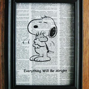 May include: Framed artwork featuring a black and white Snoopy illustration on a dictionary page. The text "Everything Will Be Alright" is below the image. The frame is black.