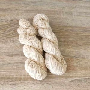 May include: Two skeins of natural coloured yarn, twisted together.