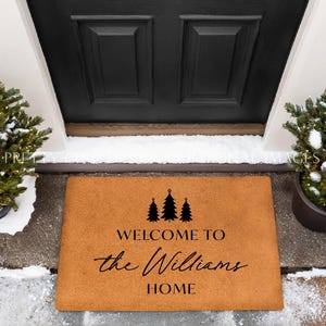 May include: A brown coir welcome mat with the text "Welcome to the Williams Home" and three stylized evergreen trees.
