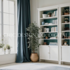 May include: A white bookshelf with teal-colored shelves filled with books, plants, and decorative items. The bookshelf is in a room with a large window and teal curtains.